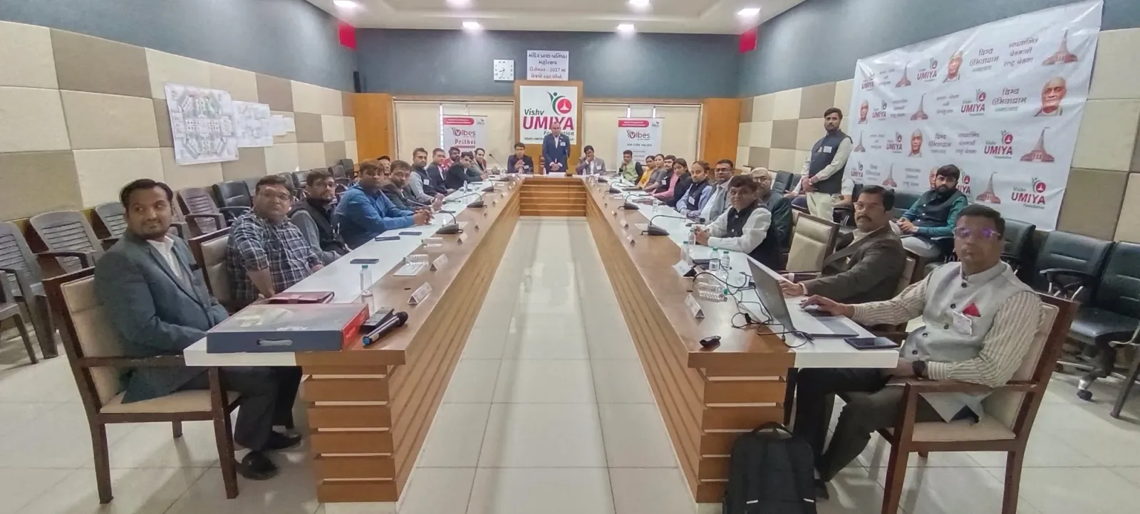 Business meeting with delegates seated around a long U-shaped conference table